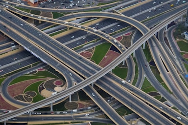 depth with layering for photo composition,how to photograph i was on vacation in dubai last week and went to the top of the burj khalifa, the tallest building in the world at just over half a mile high.  i looked down and took this photo of the road network around it.  absolutely mind-boggling how they construct all these huge roads and networks.; aerial photography of gray concrete roads