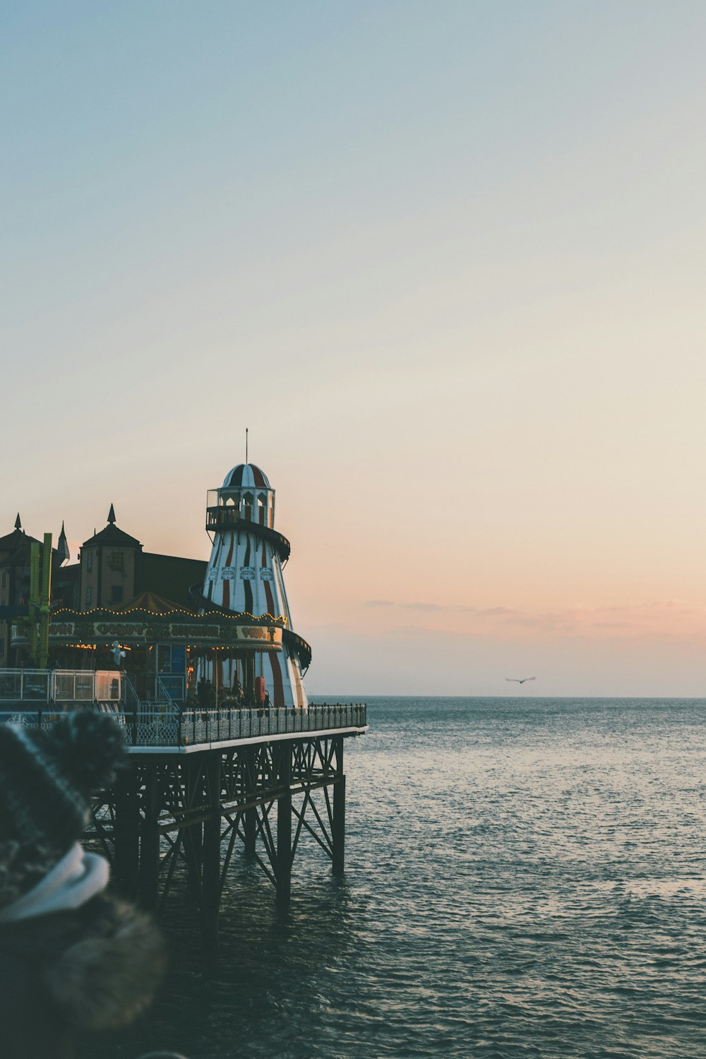 white and black lighthouse near sea during daytime