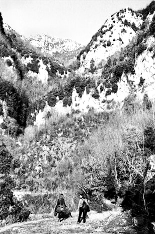 A couple exploring a scenic mountain landscape during their tour.