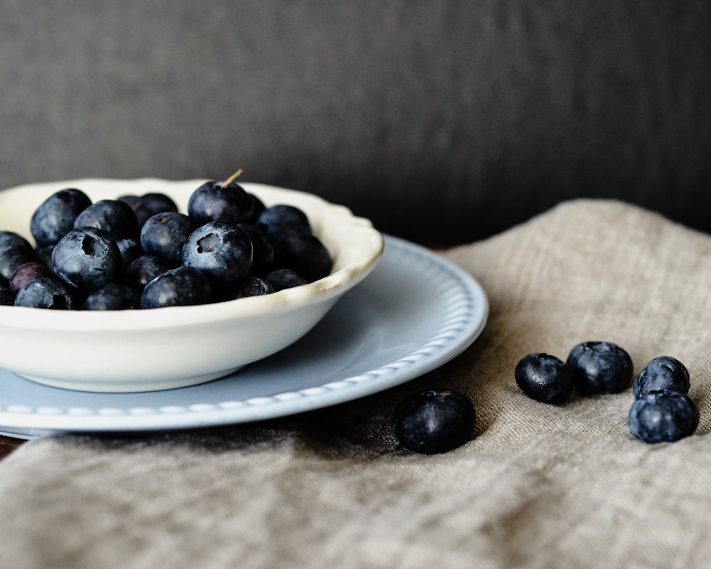 blue berry fruit on top of white owl