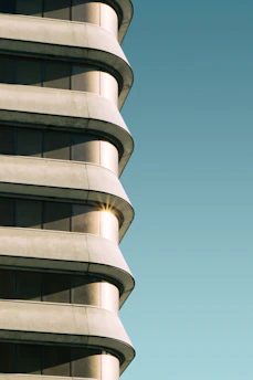 Completed contemporary building exterior with clean lines and natural stone textures under soft daylight.