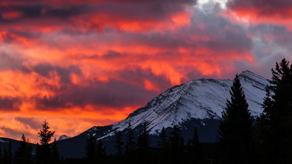 snow covered mountain under pink clouds sky