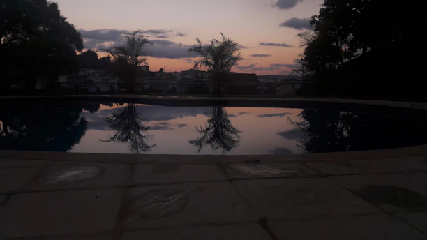 Close-up of a beautifully finished pool deck in turquoise hues during sunset.