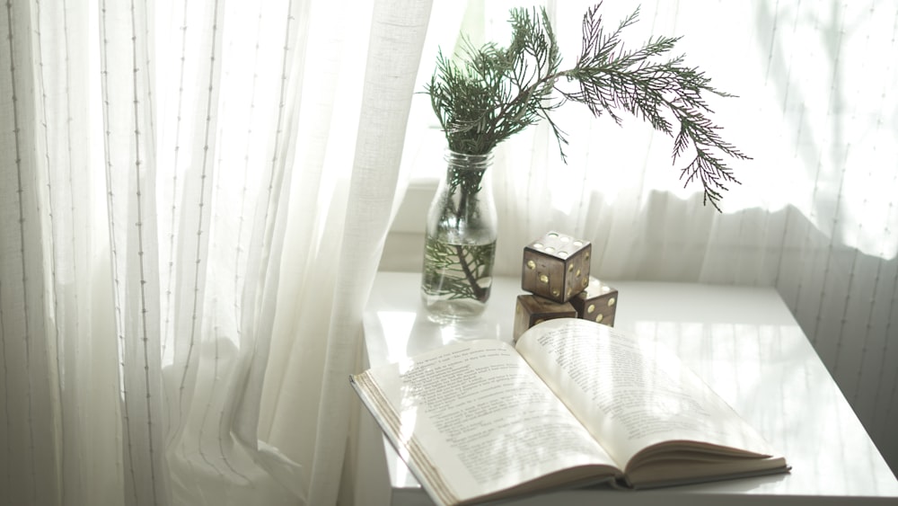 book opened on top of white wooden table