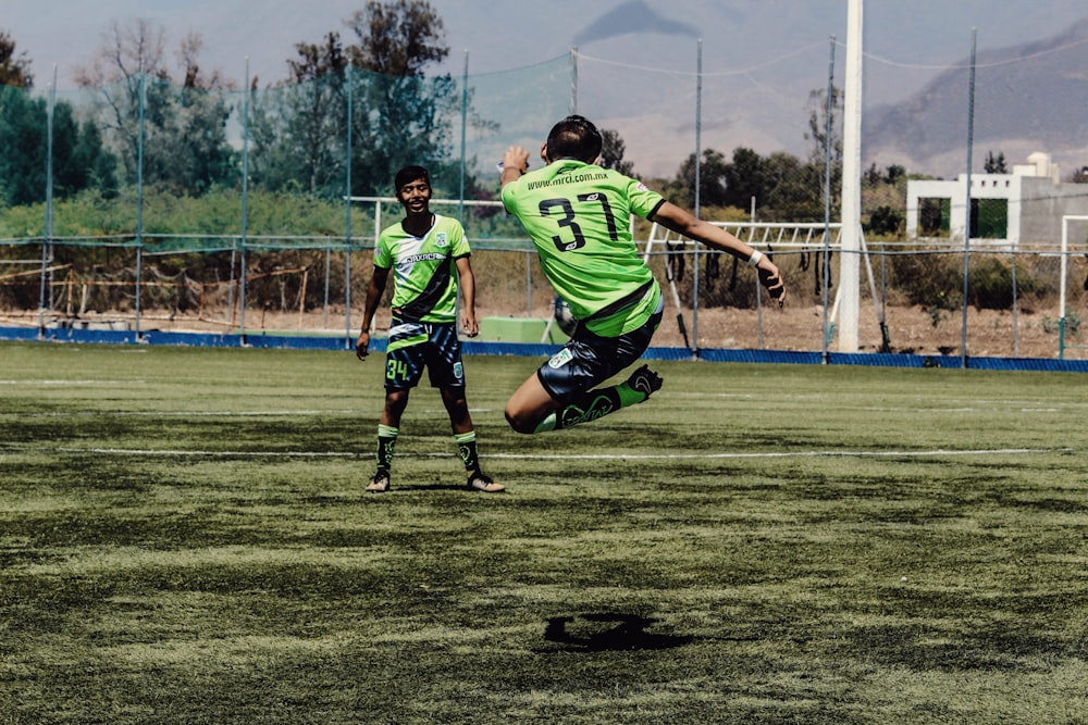 man playing soccer during daytime