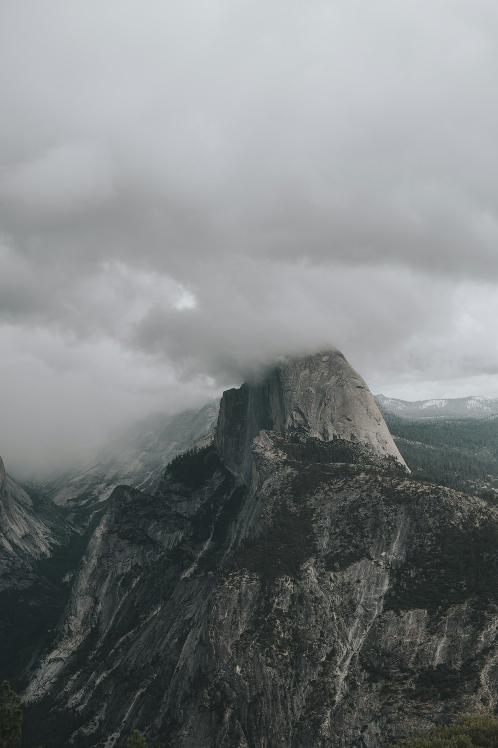 gray and green mountain under gray clouds