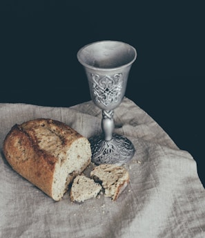 sliced of bread beside goblet