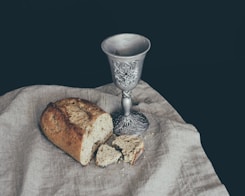 sliced of bread beside goblet
