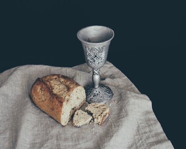 sliced of bread beside goblet