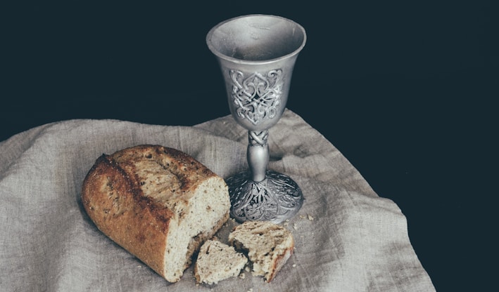 sliced of bread beside goblet