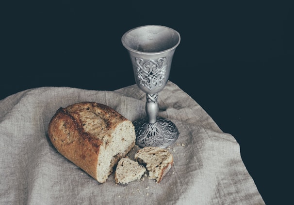 sliced of bread beside goblet