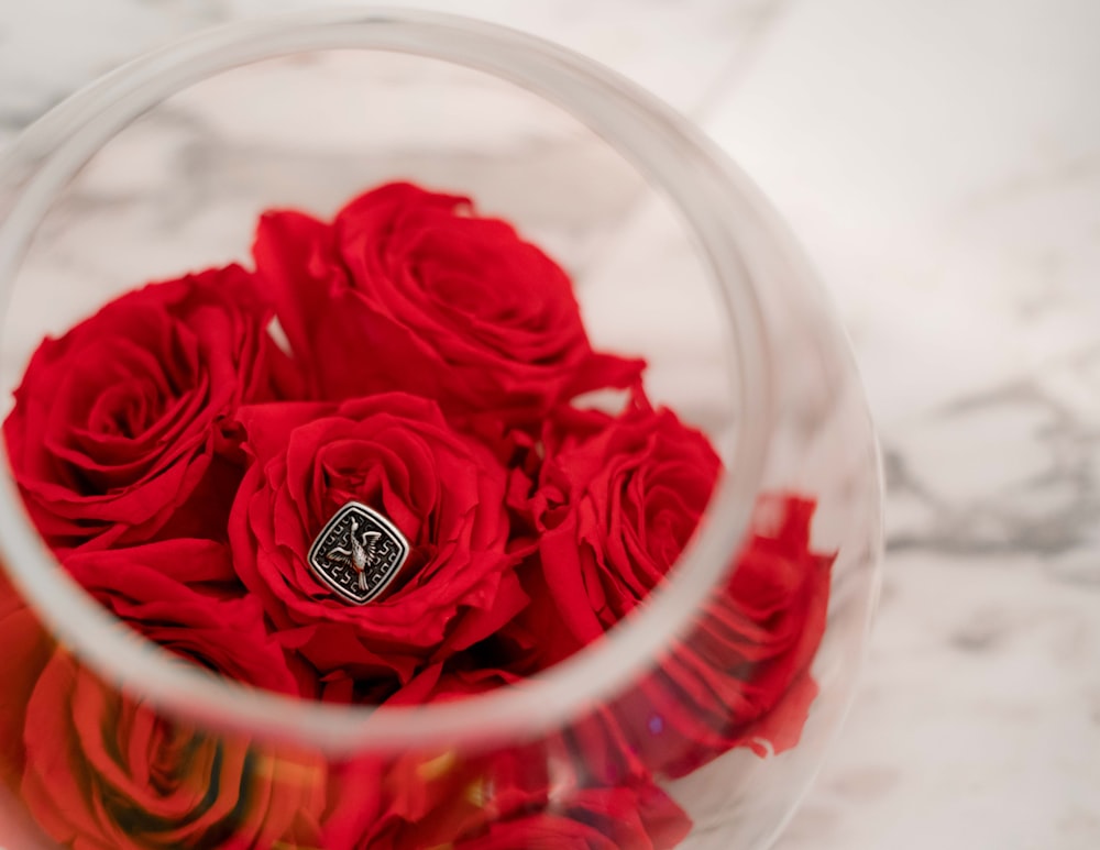 red flowers in clear glass bowl