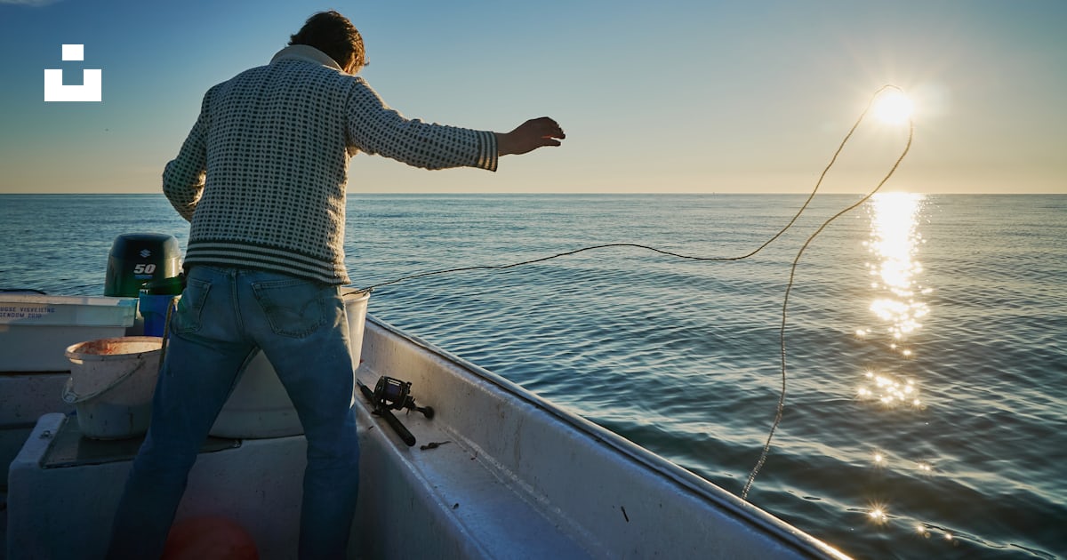 Man standing on boat throwing rope on water photo – Free Norway Image ...