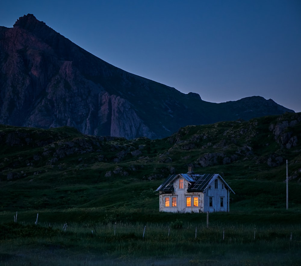 lighted house on green field