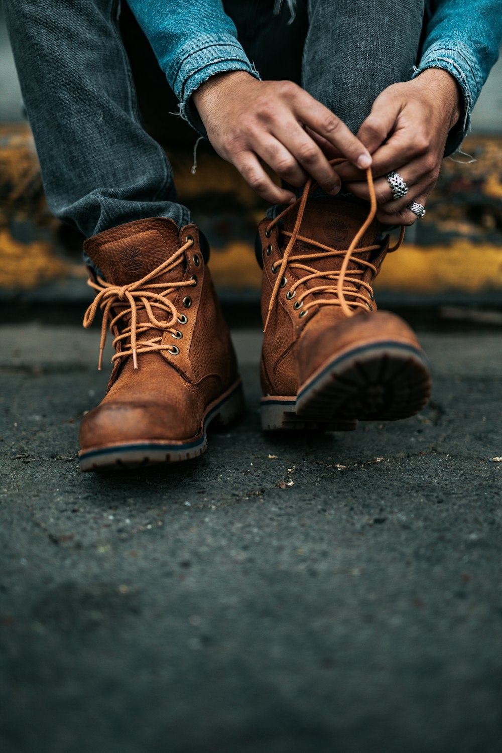 photography of person lacing his/her boots