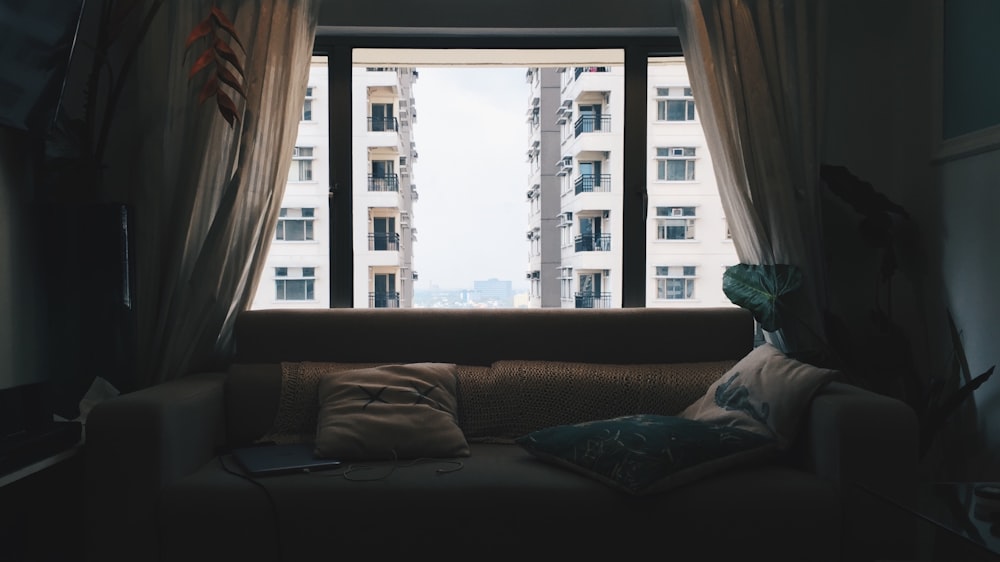 gray fabric sofa placed near window