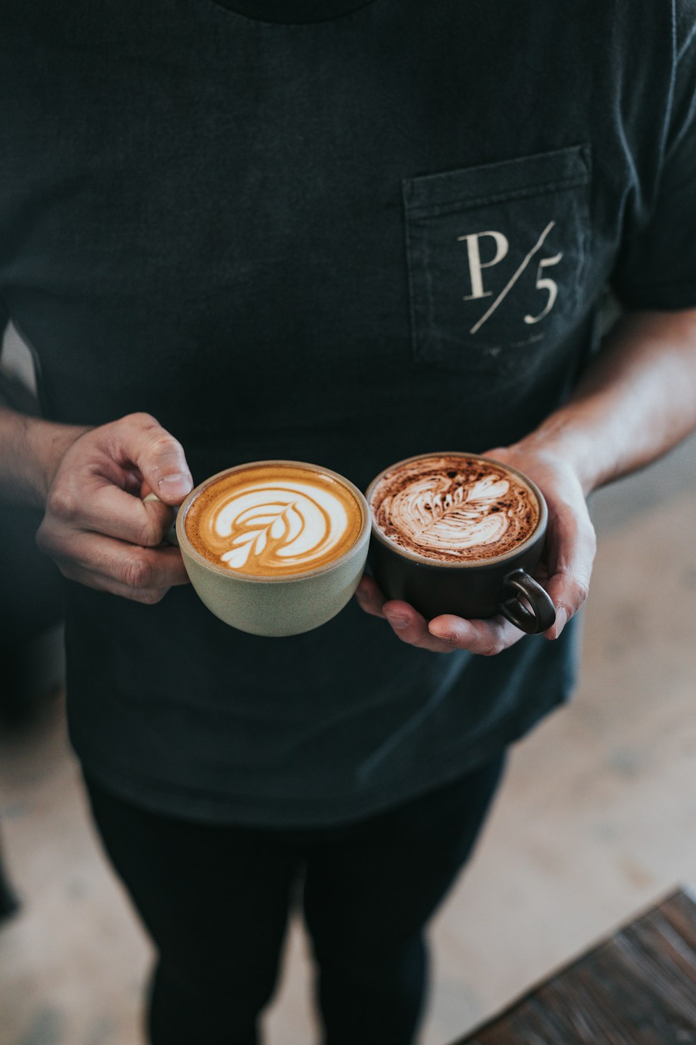 person holding two tea cups