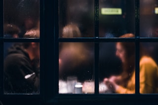 fogged window showing two person sitting