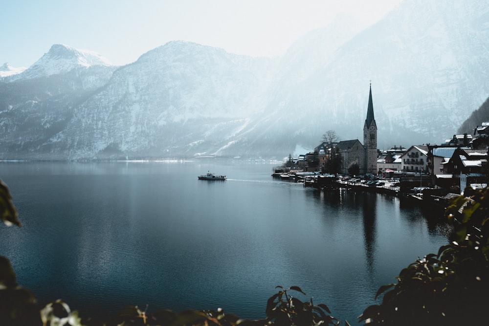 landscape photo of body of water near the mountain