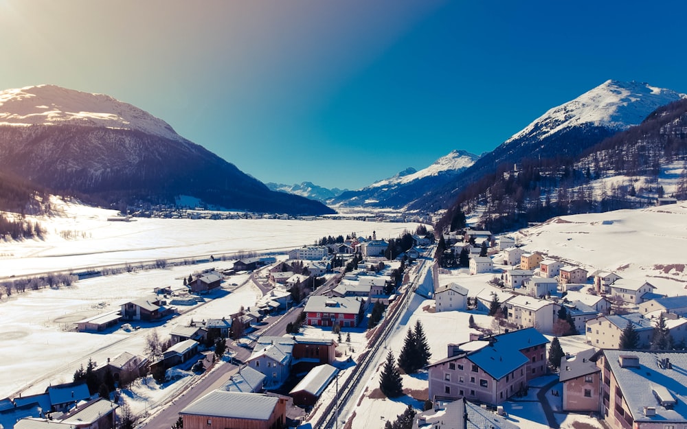 aerial photography of houses covered with snow under blue sky