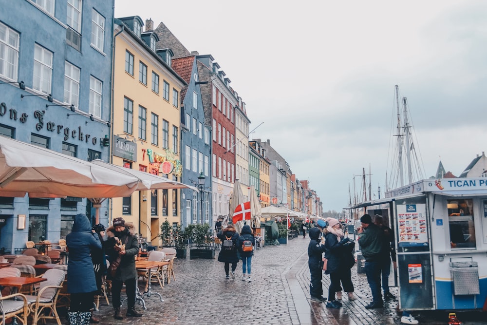 people walking building under cloudy sky during daytime