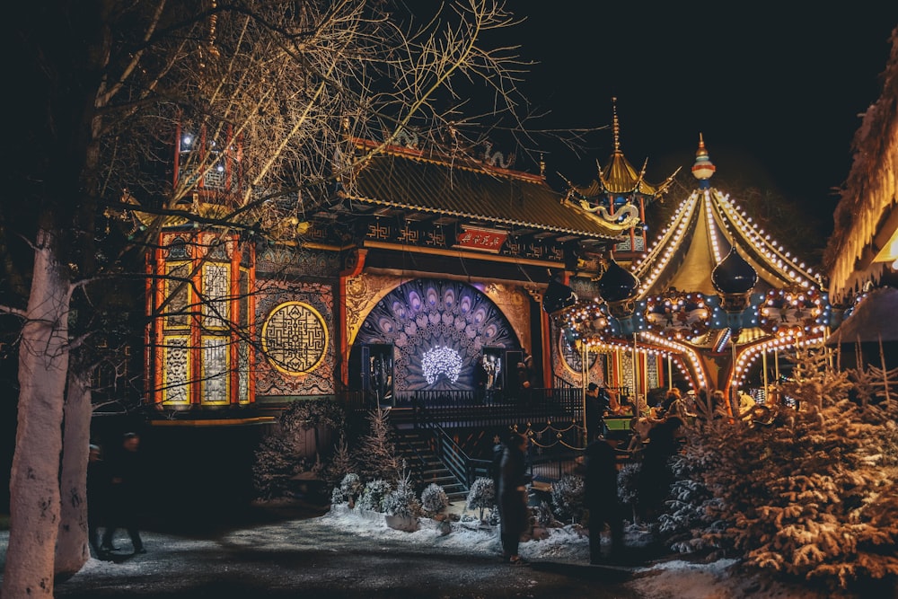 photo of people standing near carousel