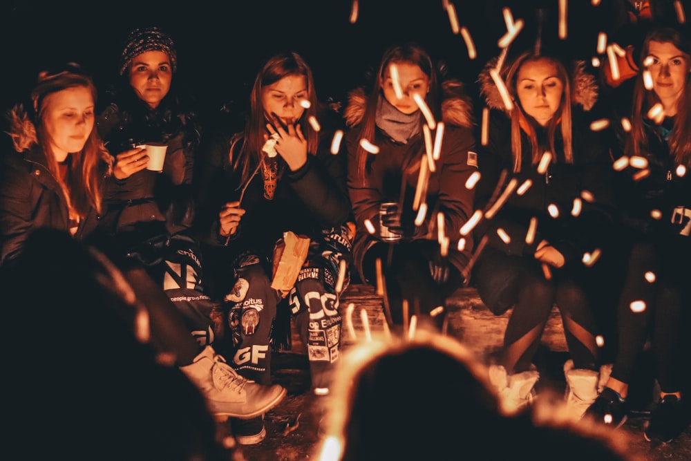 women near bonfire at night