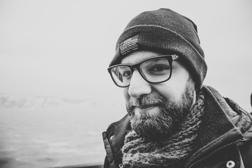 grayscale photo of man wearing knit cap