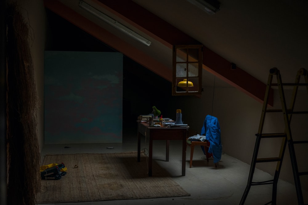 rectangular brown wooden table placed beside brown wooden armless chair inside dim light room