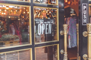A small business storefront with a 'Open' sign visible.