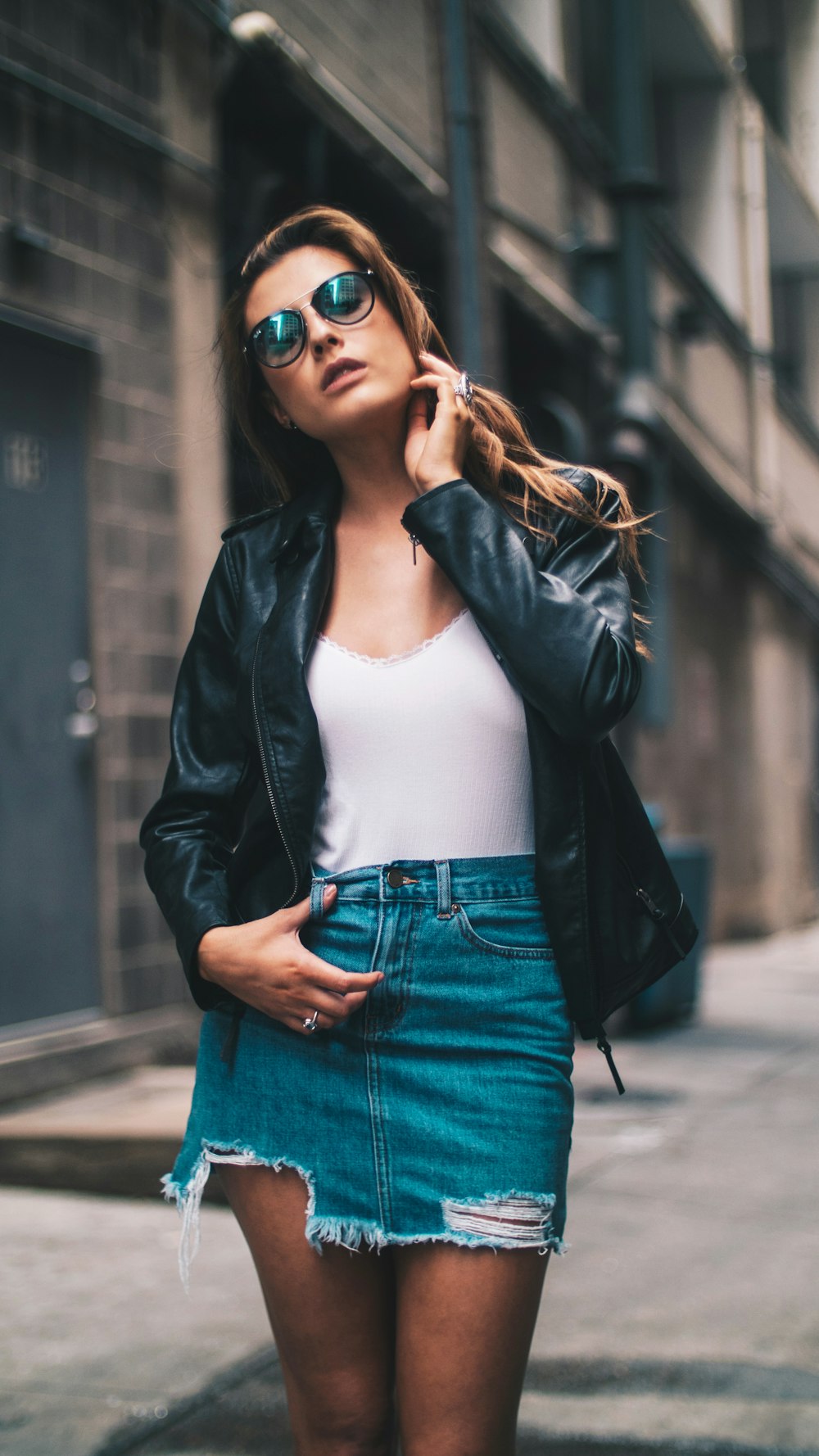 shallow focus of woman standing in alley