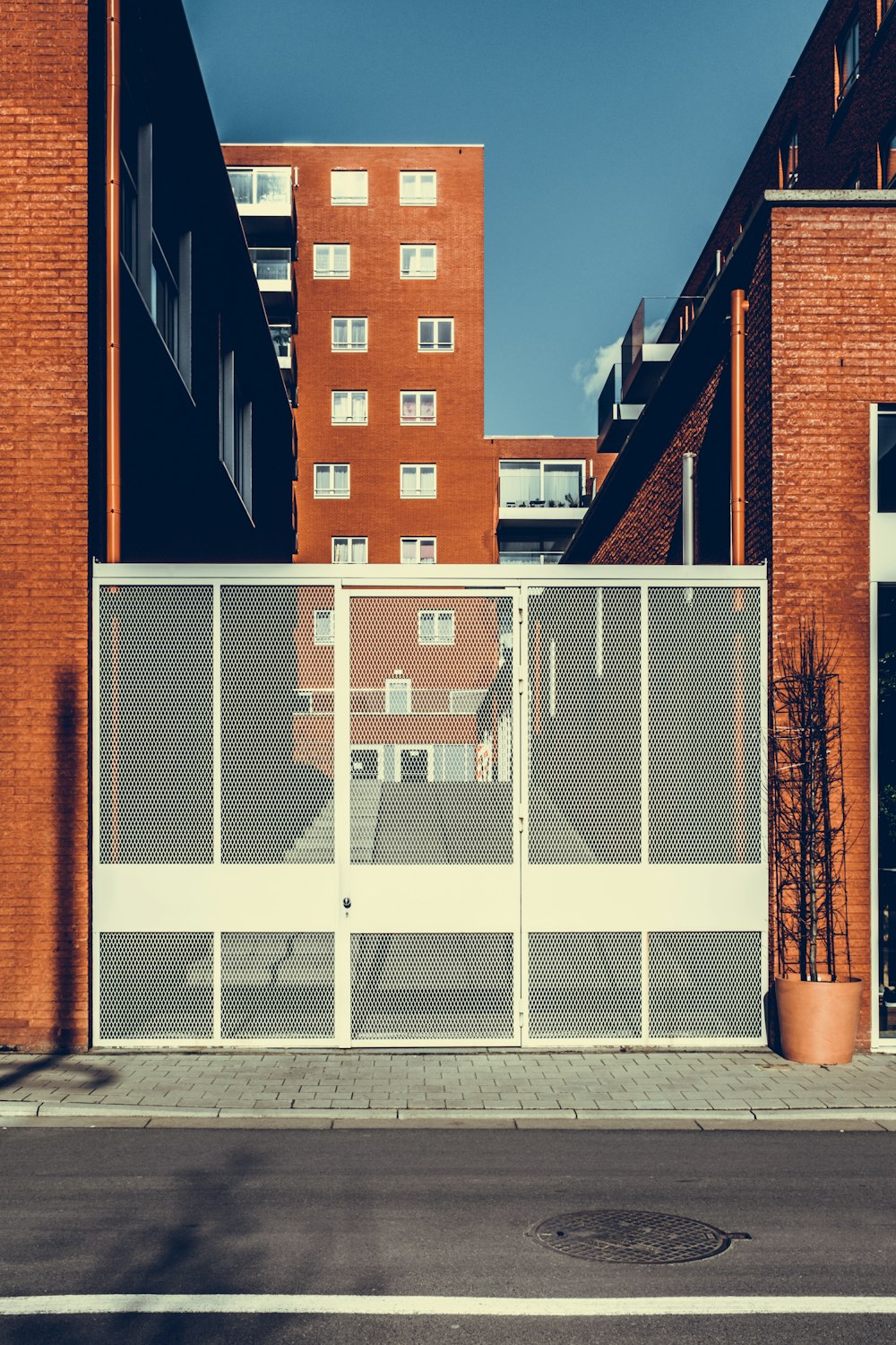 white metal gate closed during daytime