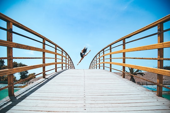 woman jumping near bridge during daytime in Lima Region Peru