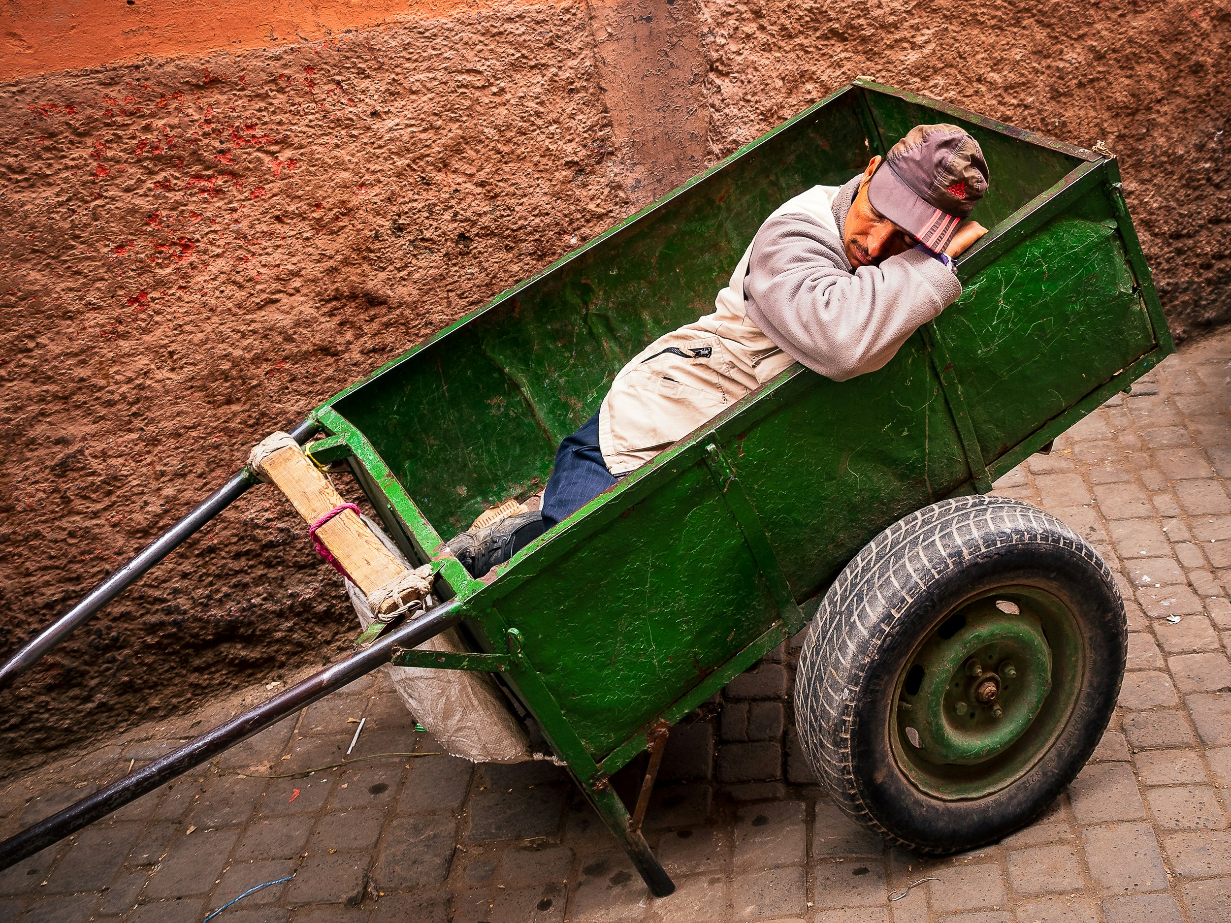 Man laying inside green wagon