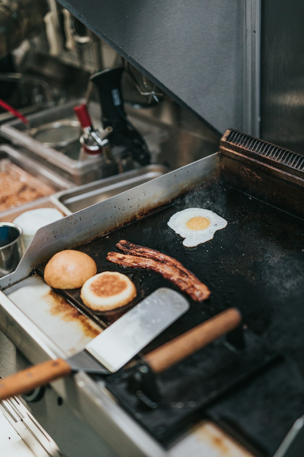 person cooking bacon, egg, and bread