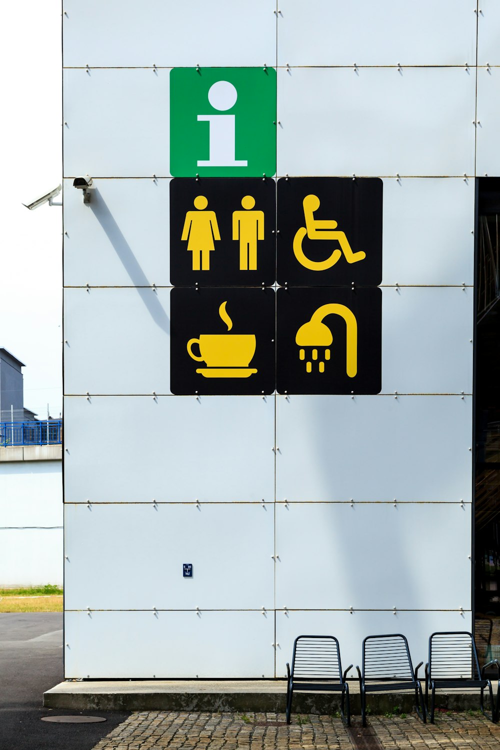 wall with security camera and signages