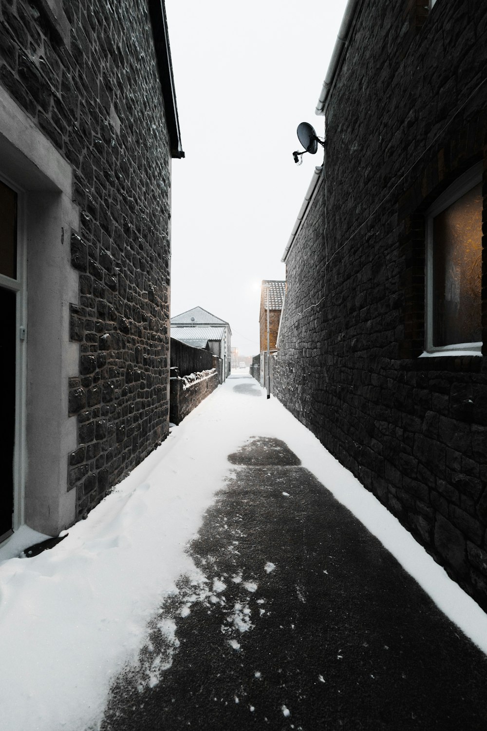 empty pathway in between the houses during daytime