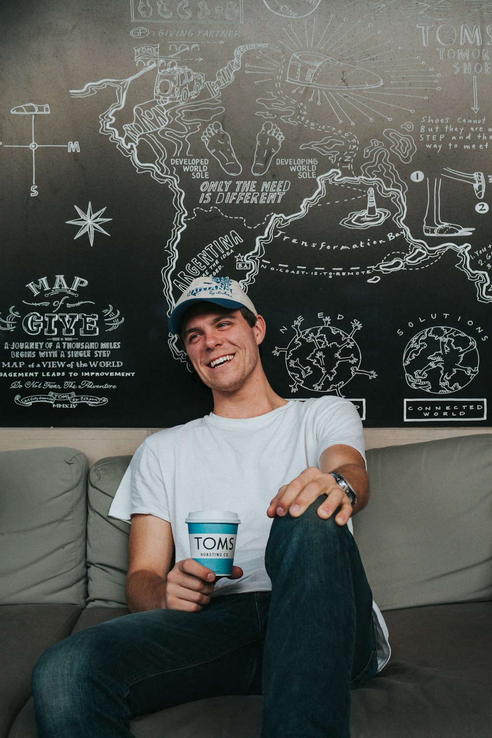 man sitting on couch while smiling