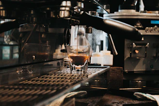 Illustration of an espresso machine pulling a shot of espresso.