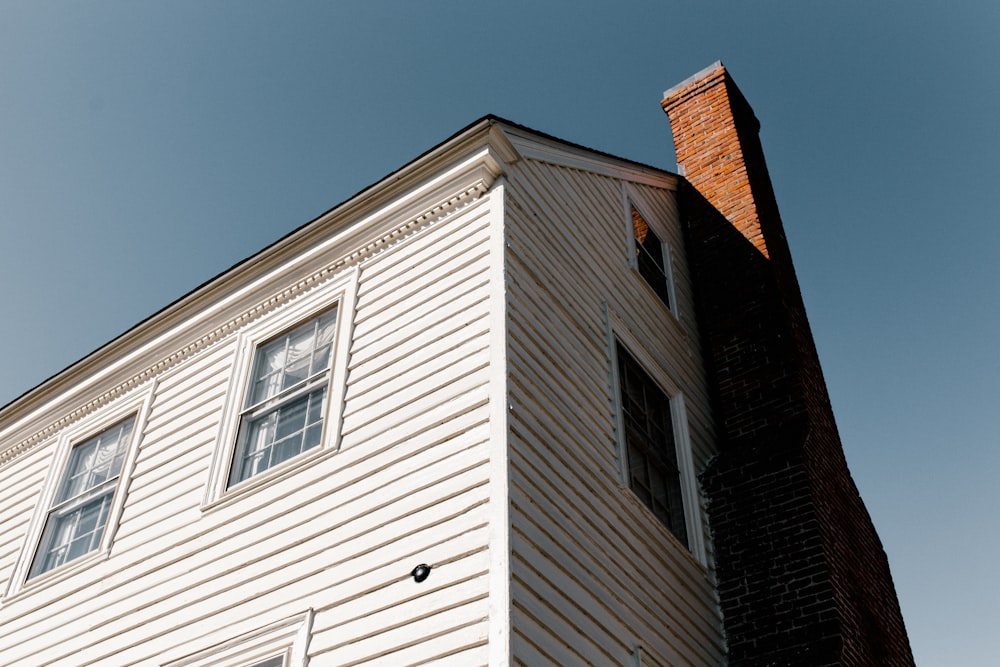 Low-angle shot of a chimney on the side of a house
