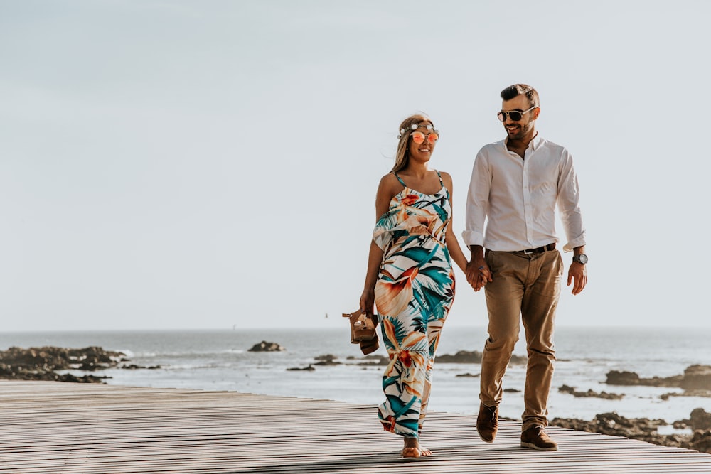 couple walking near sea at daytime