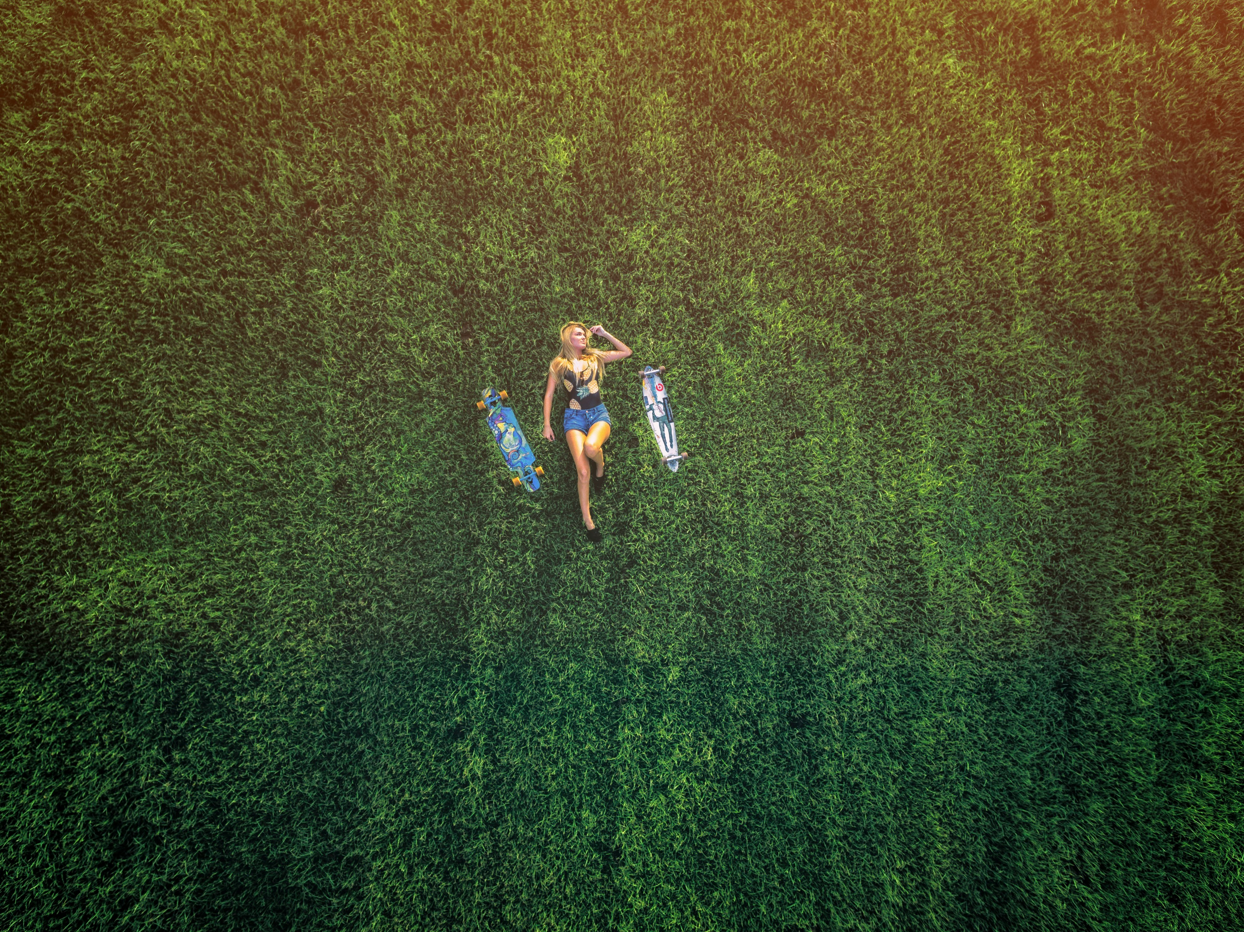 aerial view of woman laying on meadow