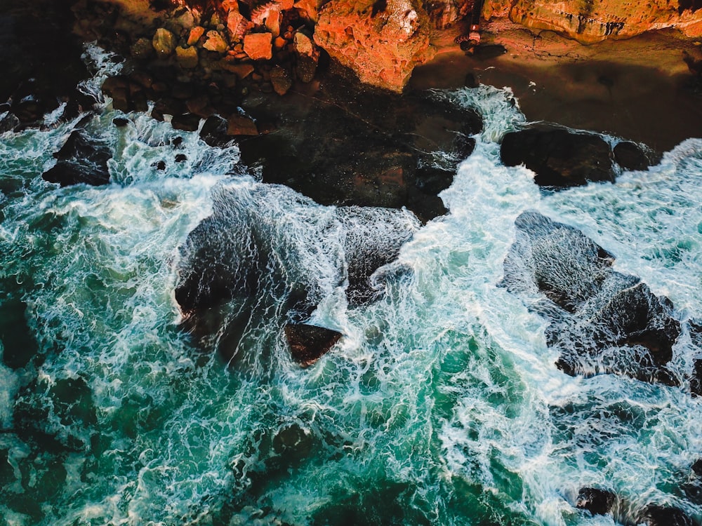 brown rock formation near the body of water photography