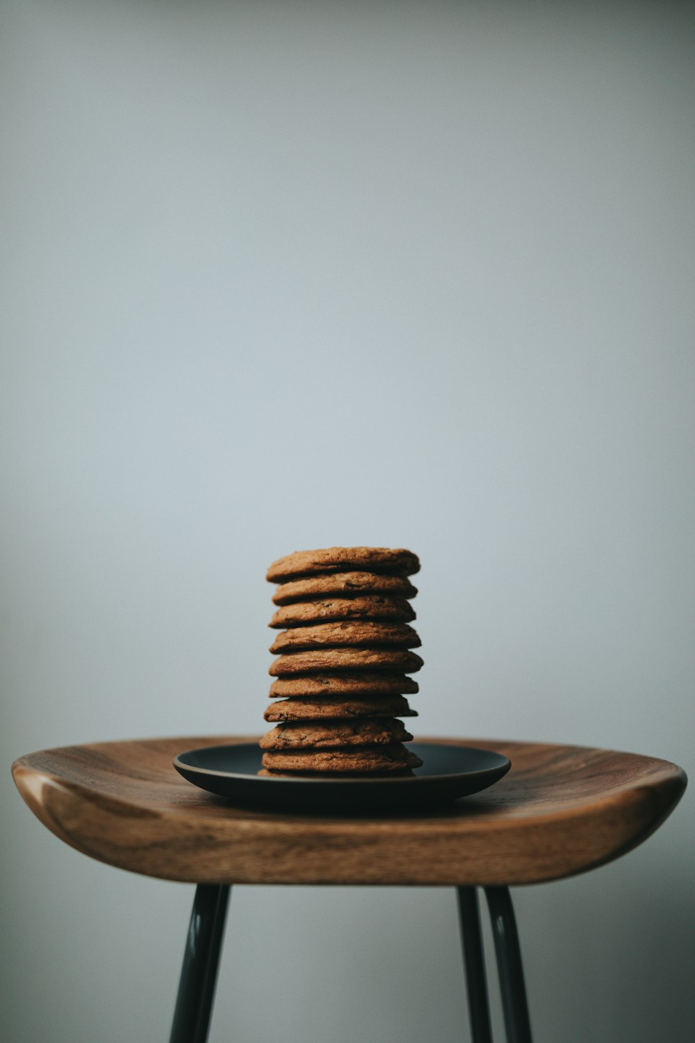 stack of brown cookies on black ceramic plate