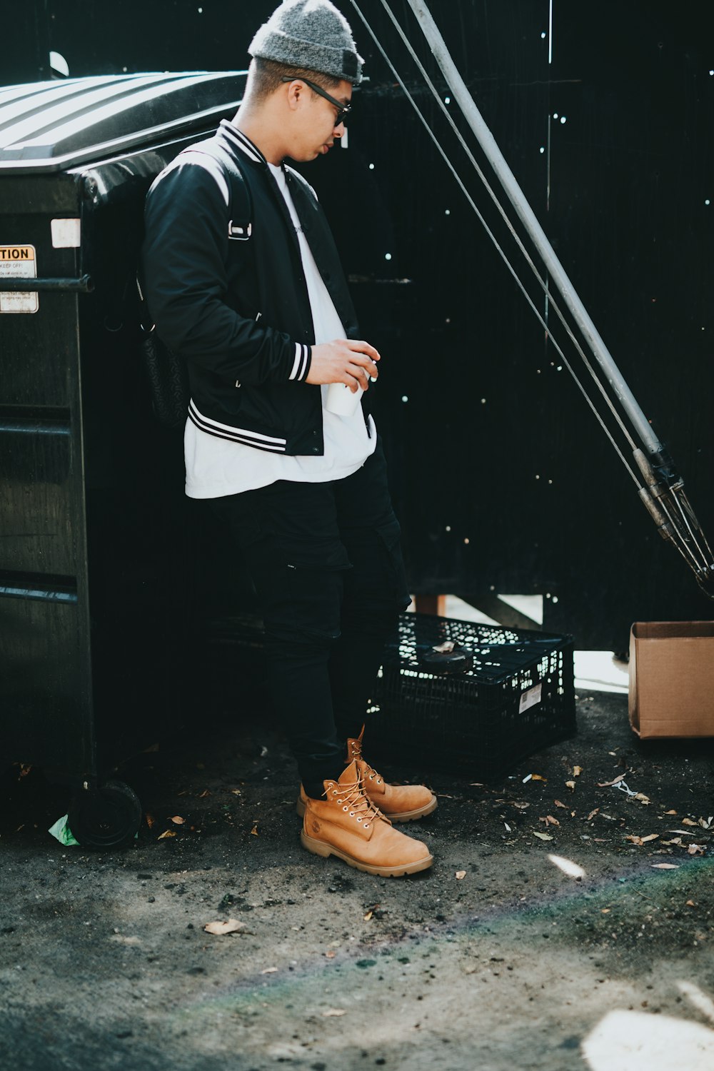 man standing beside black metal dresser