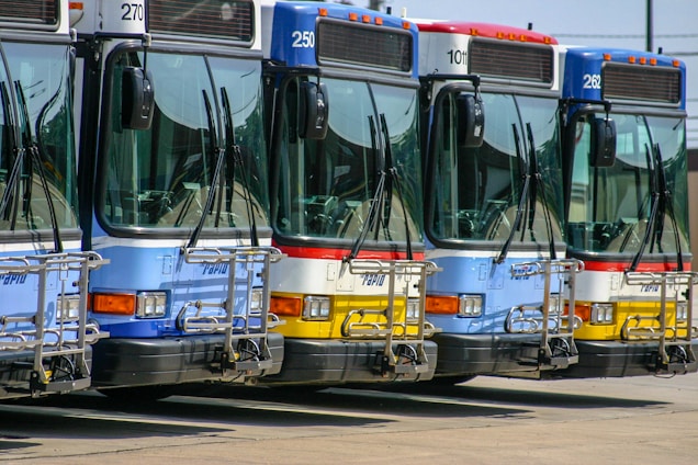 A fleet of comfortable buses lined up ready for municipal passenger transport.