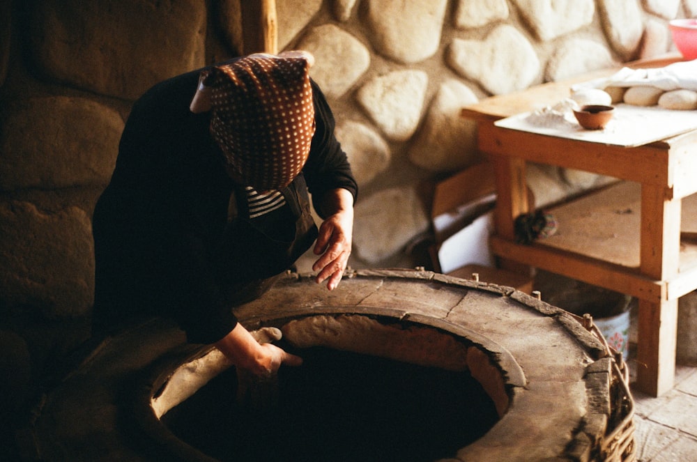 a person in a room with a large piece of wood