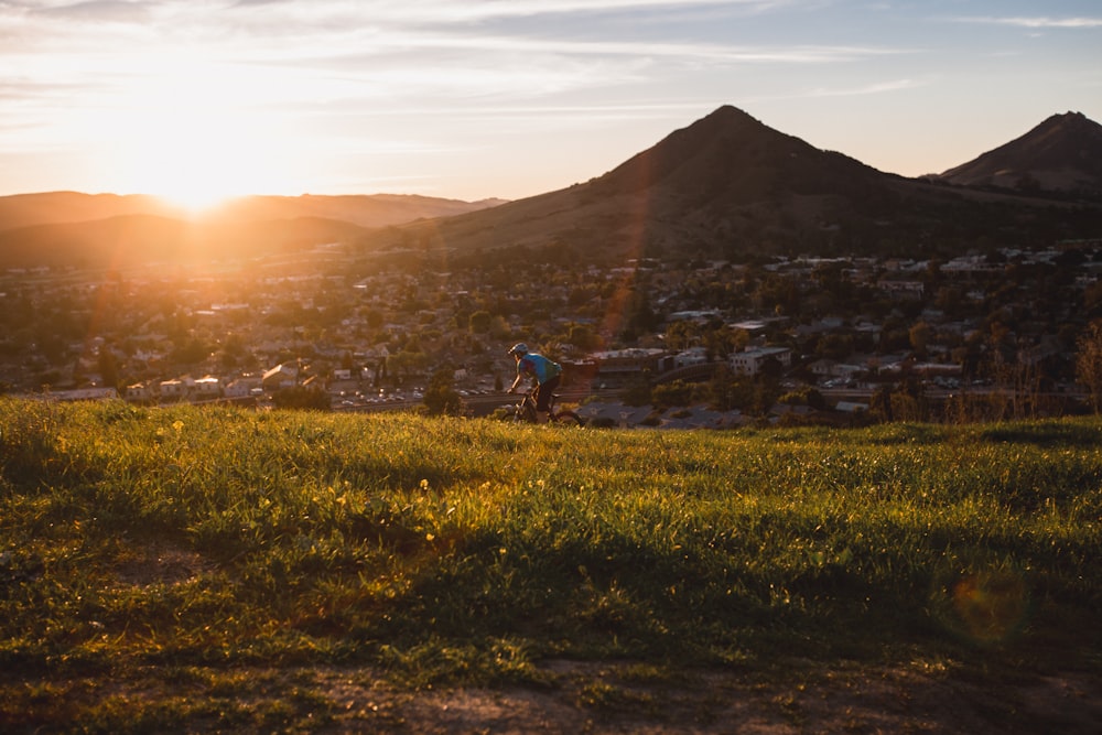 man riding bicycle during sunset