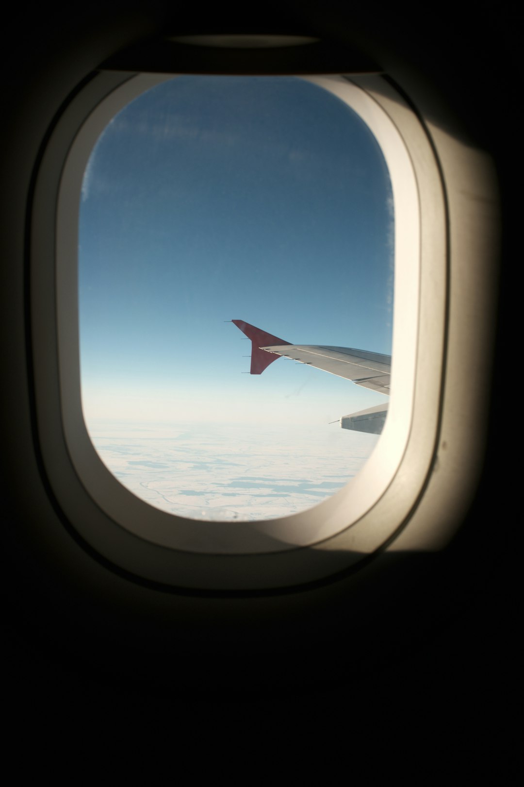 aircraft wingtip photography inside airplane above clouds at daytime