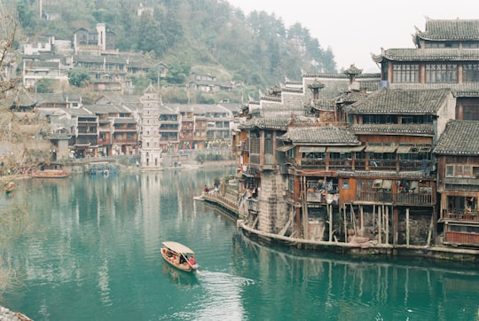 boat near wood building in Fenghuang China